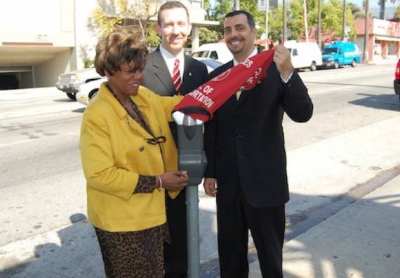 Amir Sedadi pulls the hood off a parking meter.  Photo:##http://laist.com##LAist##