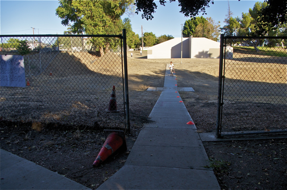 The extension of Norfolk St. would have passed between the cones on the sidewalk and the fence on the hillside on the left, requiring the removal of the handball courts. Sahra Sulaiman/LA Streetsblog