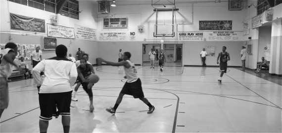 Young men play basketball during the Summer Night Lights program at the Jordan Downs rec center. It's one of the few opportunities for young men to be out late at night. Sahra Sulaiman/LA Streetsblog