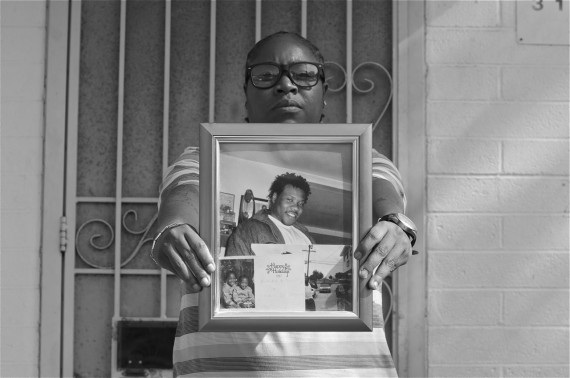 Sherika Simms holds the last photo taken of her brother, Maurio Proctor, outside one of their childhood apartments in Jordan Downs. Sahra Sulaiman/LA Streetsblog