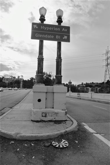 Heading up the Glendale-Hyperion bridge into Silver Lake. Appropriately, the battered and painted over sign at the base of the lights reads "DANGER."  Sahra Sulaiman/LA Streetsblog