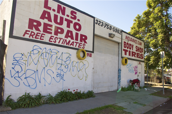 A member of a diabetes group at St. John's picks up trash along 58th St., one block north of Slauson. Sahra Sulaiman/LA Streetsblog