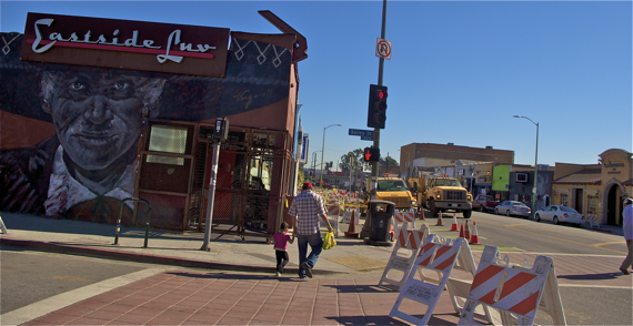 A man and his child navigate the construction along 1st St. in Boyle Heights. Sahra Sulaiman/LA Streetsblog