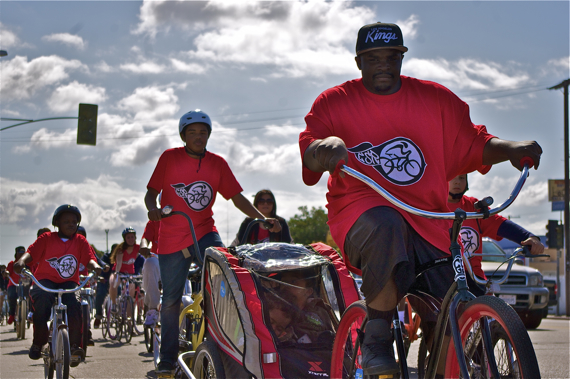 The East Side Riders' Ride4Love has always been about family, community, and service. Here, ESRBC co-founder Tony August-Jones brings his sons along while nephew Joshua Jones ensures they stay in the carrier. Sahra Sulaiman/Streetsblog L.A.