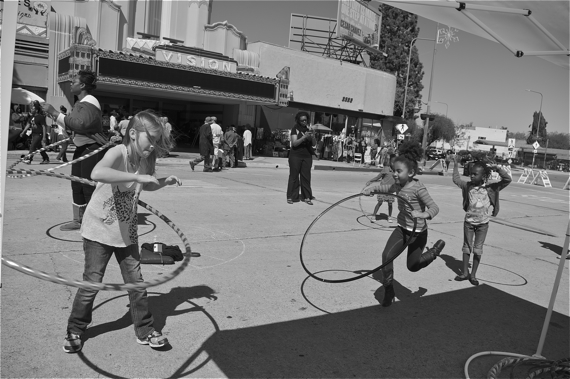 Hula-hooping in front of the Vision Theater. Sahra Sulaiman/LA Streetsblog