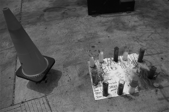 Candles and well-wishes mark the site where Big Yummie was killed in the Gonzaque (formerly the Haciendas) housing development. The candles are red to mark his affiliation with a set of the Bloods. Sahra Sulaiman/LA Streetsblog