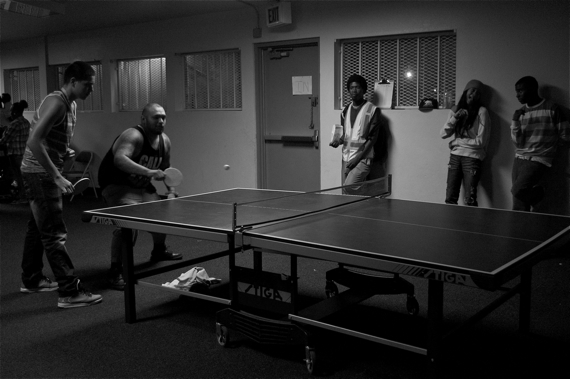 Workers from the Summer Night Lights program at Jordan Downs play an intense game of ping pong. The program is intended to keep at-risk youth safe and occupied in the summer, as there hardly any recreational opportunities for them in places like Watts. Sahra Sulaiman/LA Streetsblog