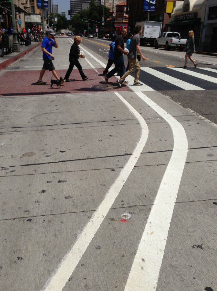 Work is underway for Downtown L.A.'s Broadway "Dress Rehearsal." The street has fresh new striping for bulb-outs, also new zebra crosswalks. photo Joe Linton/Streetsblog L.A.