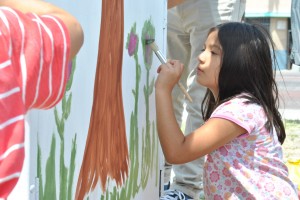Linsay Rosales, 6, helps paint a electric box during a pop-up plaza event in Pacoima on April 19.