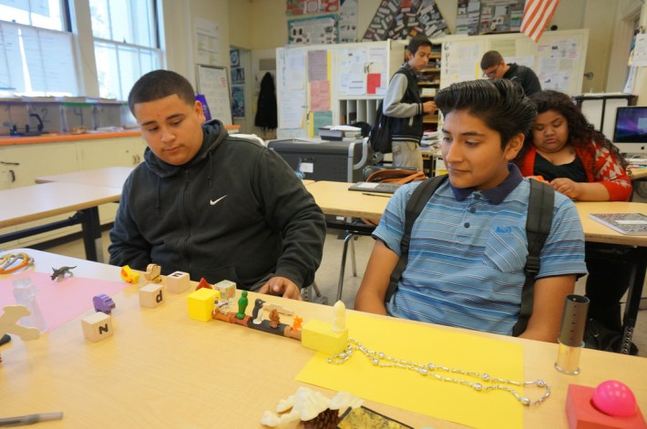 Alex Chupina, left, and Javier Cortez work on their model of a re-envisioned Metro Goldline that offers free rides to passangers