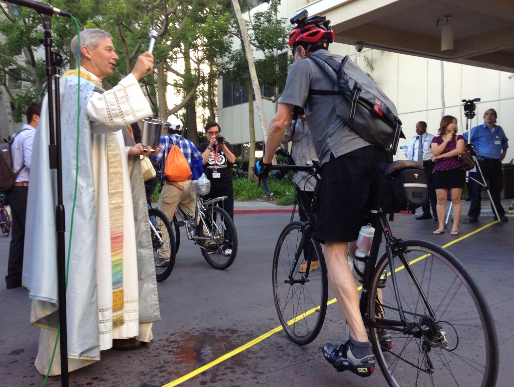 Eyes on the Street: Priest sprinkles holy water at the 11th annual Blessing of the Bicycles which took place yesterday at Good Samaritan Hospital. Photo: Joe Linton/Streetsblog LA