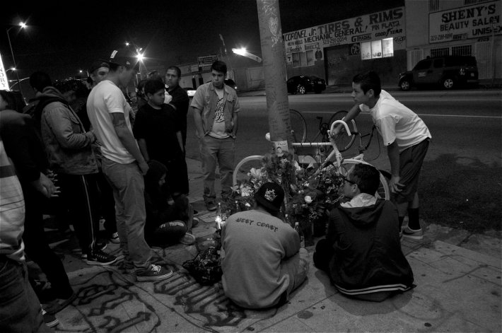 Friends of Oscar Toledo, Jr., gather around the ghost bike put up at 47th and Normandie in South LA. Sahra Sulaiman/Streetsblog L.A.