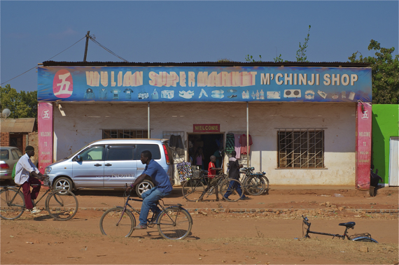 Bikes pass in front of a market stand near the center of Mchinji. Sahra Sulaiman/Streetsblog LA