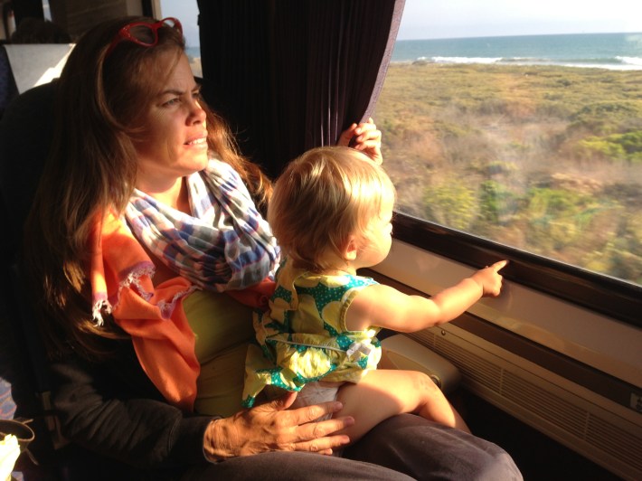 Joe's one-year-old daughter Maeve sitting on her mom's lap on the Amtrak Surfliner last weekend. Photo: Joe Linton/Streetsblog L.A.