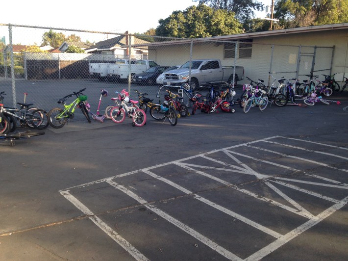 One kid. One kids bikes to school regularly. This was one of three bike storage areas on Friday