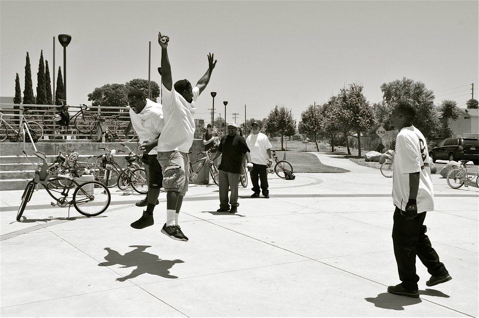 Why an after-party? Because riding bikes often makes people feel like this. The co-founders of the East Side Riders jump for joy at the Watts Towers. Sahra Sulaiman/Streetsblog L.A.