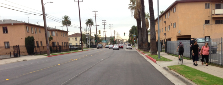Preliminary striping on Venice Boulevard at Wilton. Cyclists and pedestrians compete for sidewalk space, while cars get four lanes and parking.