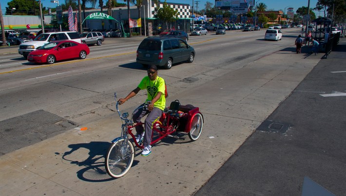 Fred Buggs, president of the East Side Riders and builder of incredible bikes, heads back toward an intersection to help shepherd rides through it. Sahra Sulaiman/Streetsblog L.A.