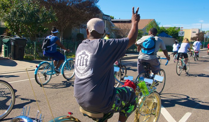 Tyrone "T-money" Williams of the South L.A. Real Rydaz waves to Watts residents. Sahra Sulaiman/Streetsblog L.A.