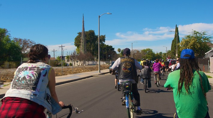 Riders make their way toward the Watts Towers. Sahra Sulaiman/Streetsblog L.A.