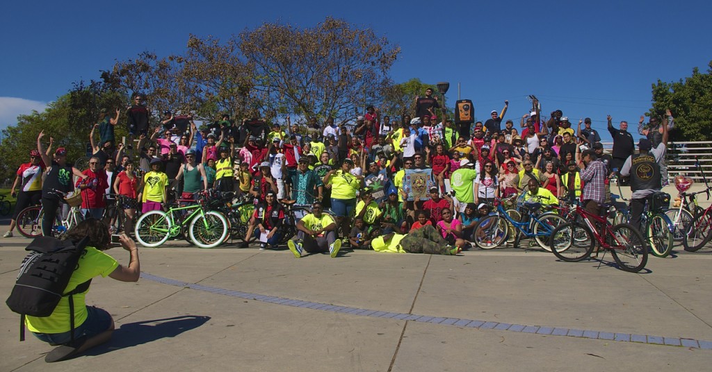 Riders gather for a photo at the Watts Towers. Sahra Sulaiman/Streetsblog L.A.