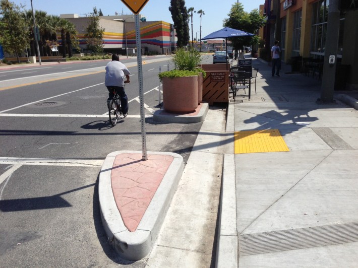Curbs and planters prevent drivers from colliding with the Mednik parklet