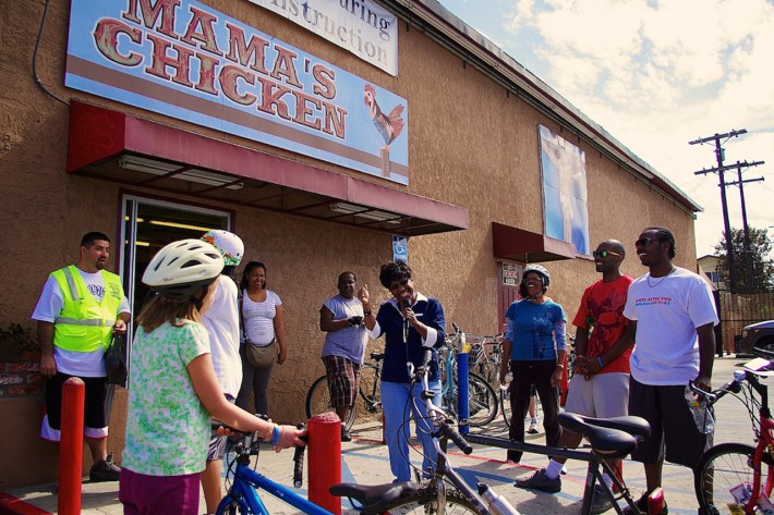 Riders on the healthy food tour gather in front of Mama's Chicken, a corner market that has undergone a conversion and now features some produce provided by CSU. Sahra Sulaiman/Streetsblog L.A.