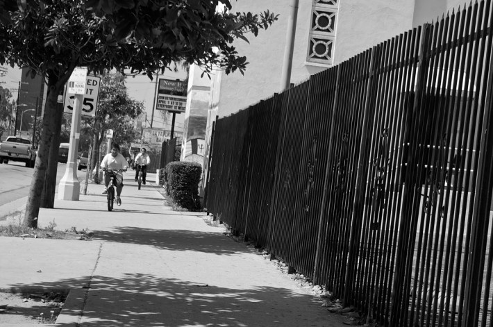 A father and son ride their bikes along Central Avenue's sidewalks on a Sunday afternoon. Sahra Sulaiman/Streetsblog L.A.