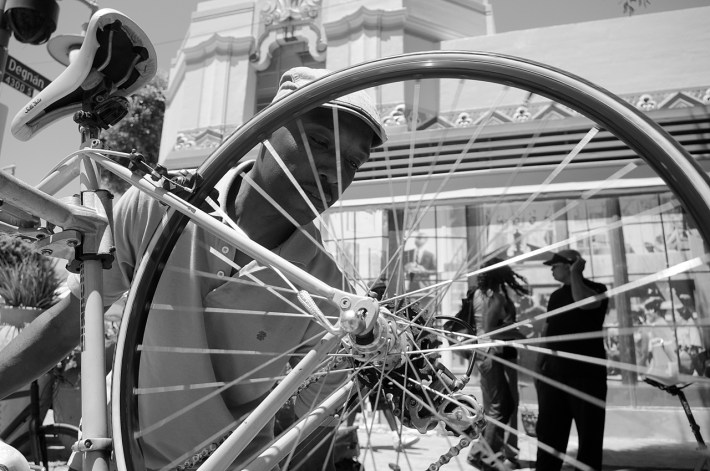 Ade Neff, founder of Ride On!, works on wheel. Sahra Sulaiman/Streetsblog L.A.