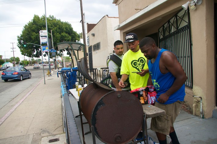 Chucc Standokes and John Jones fire up the grill while Miguel Partida of Los Ryderz looks on. Sahra Sulaiman/Streetsblog L.A.