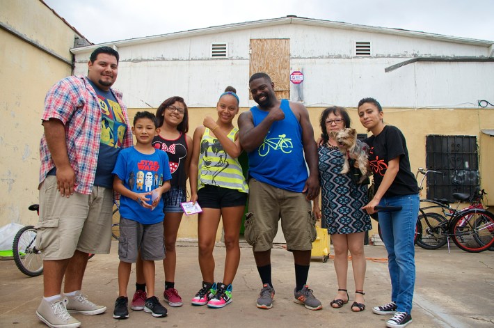 John Jones III, center, stands with supporters of the East Side Riders' new co-op space in Watts. Sahra Sulaiman/Streetsblog L.A.