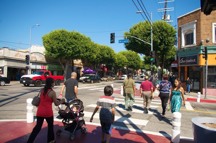 Pedestrians cross at St. Louis and Cesar Chavez, where new bulb-outs were recently installed by the Great Streets program. Sahra Sulaiman/Streetsblog L.A.