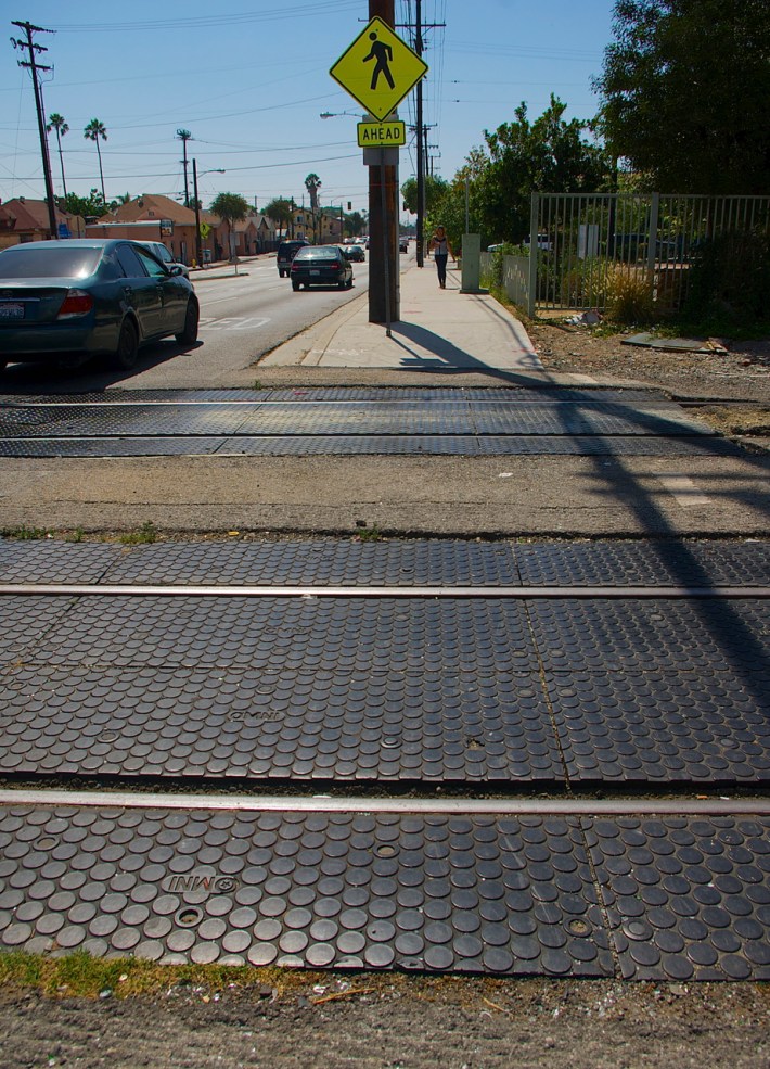 There are no pedestrian barriers at Gage Ave., even though the tracks run adjacent to a park heavily used by children. Sahra Sulaiman/Streetsblog L.A.