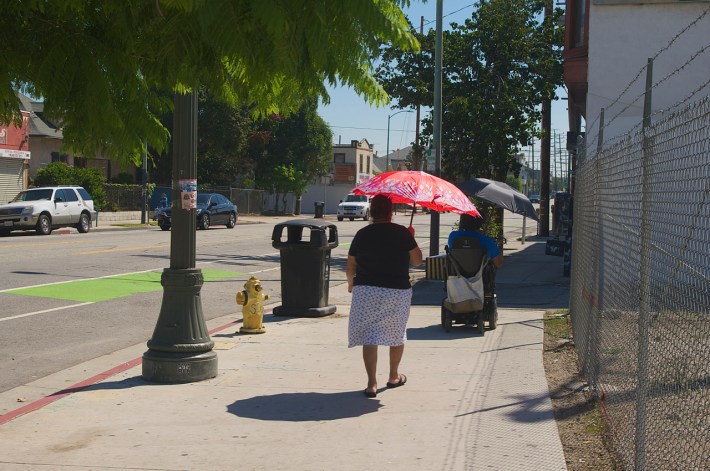 Umbrellas rule the day on a baking hot Saturday in Boyle Heights. Sahra Sulaiman/Streetsblog L.A.