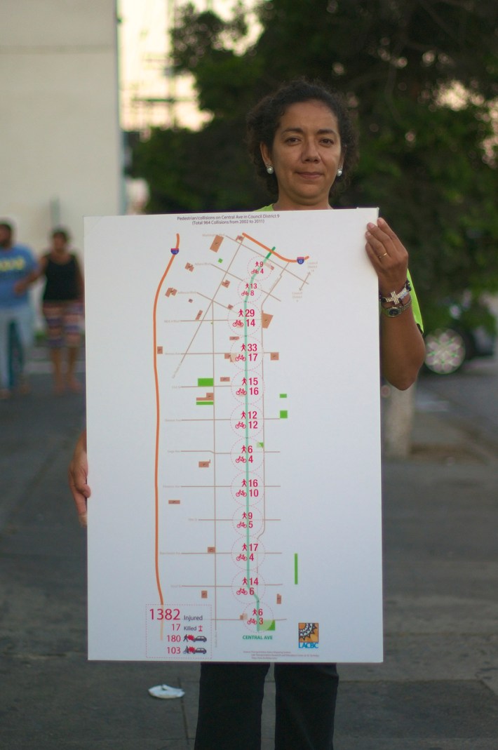 Araceli Alvarado holds a map of Central Ave. showing the number of collisions involving pedestrians and cyclists. Sahra Sulaiman/Streetsblog L.A.