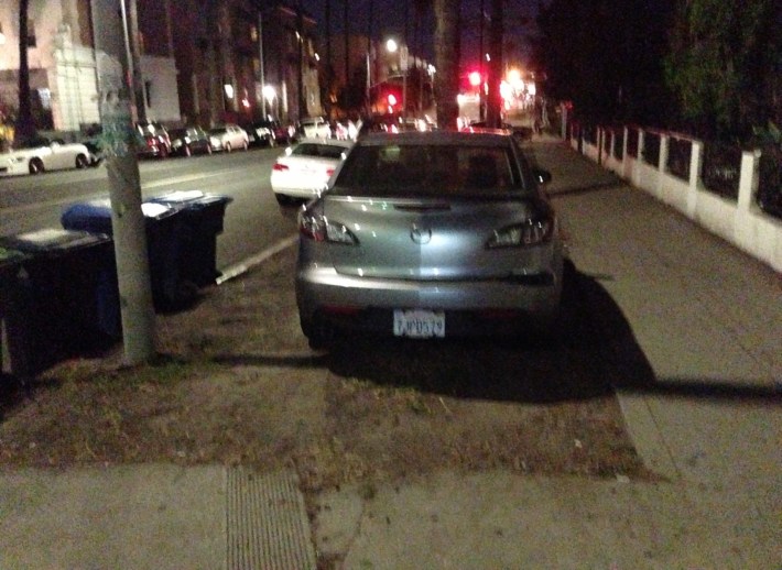 Car on the curb on First Street near Vermont Avenue.