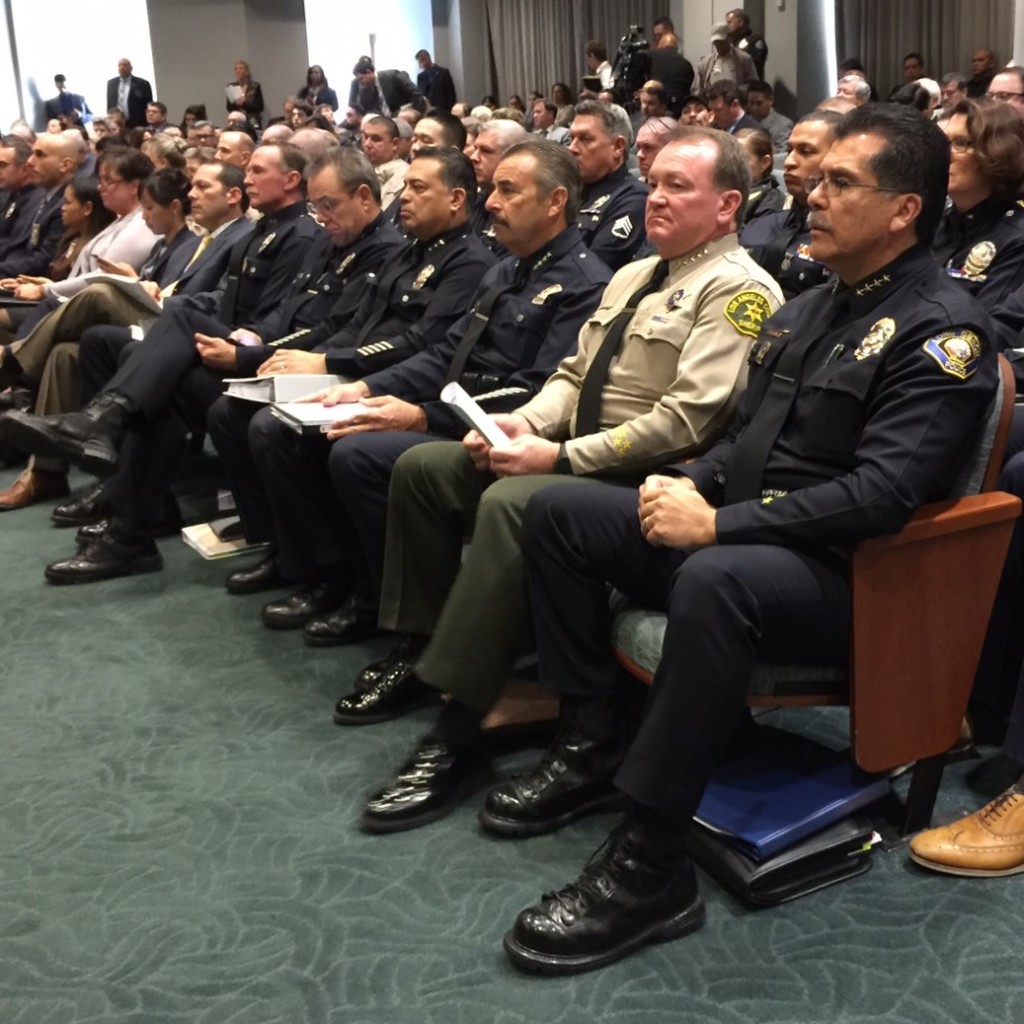 Seated in the front row are LAPD Chief Charlie Beck, LA County Sheriff Jim xxx