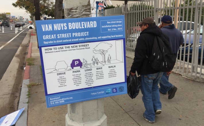 Signage posted on Van Nuys to explain how parking-protected bike lanes work