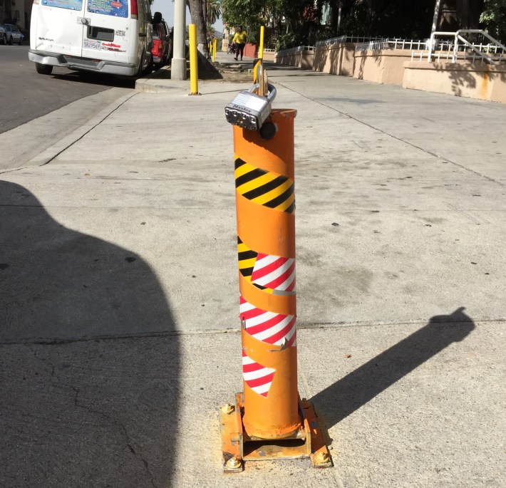 This Koreatown anti-parking post is a locked retractable bollard