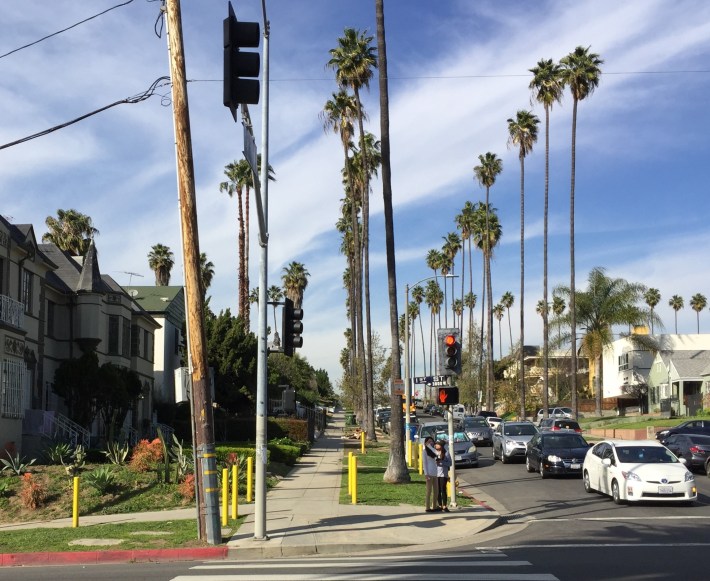 A dozen yellow posts at the corner of First and Catalina Streets