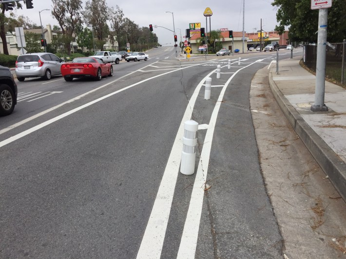 Posts protect the bike lane as it veers right off of Sunland Boulevard onto Foothill