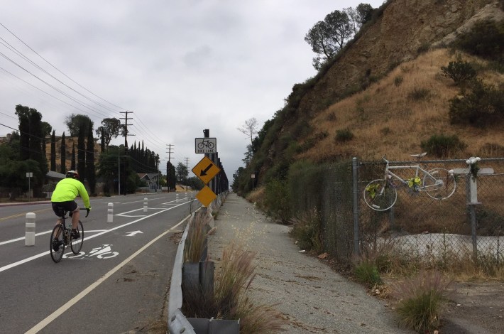 A ghost bike memorializes cyclist Jeff Knopp killed by a truck on this stretch in 2016