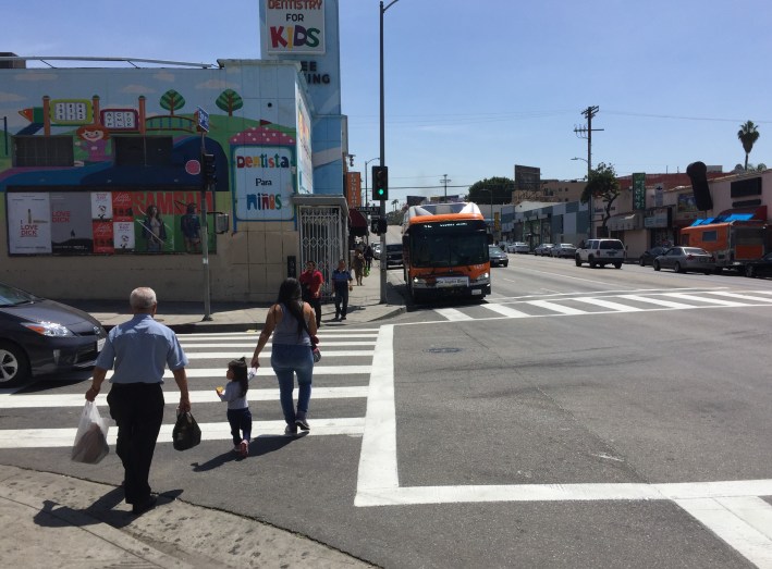 Mostly I observed buses pulling entirely into the curb extension area, which allows cars to continue to pass in the through lane