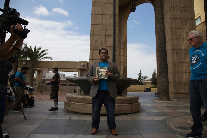 Manuel Criollo, Director of Organizing at the Labor Community Strategy Center, holds a photo of Cesar Rodriguez during yesterday's press conference. Sahra Sulaiman/Streetsblog L.A.