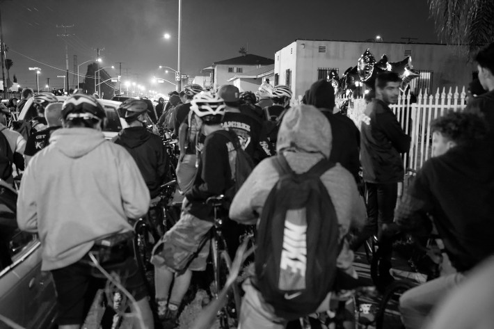 Riders gather outside the home of Beverly Owens, Frazier's mother, to pay their respects Friday night. Sahra Sulaiman/Streetsblog L.A.
