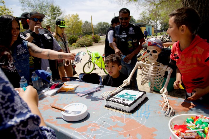 Long-time club supporter Terri Calderon presents the club (and its de facto mascot) with a cake to celebrate. Sahra Sulaiman/Streetsblog L.A.