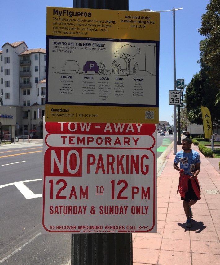 Signage explaining the new parking-protected bike lanes on MyFigueroa