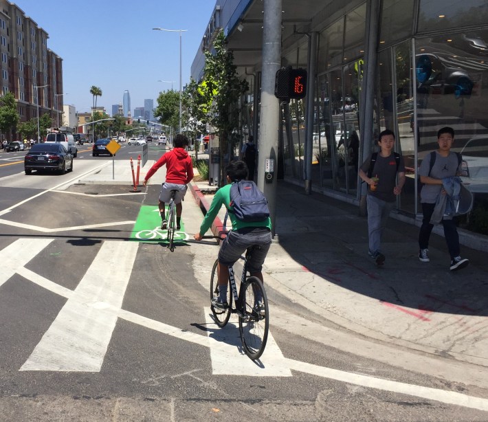 Intermittent green paint designates bike lane and highlights conflict zones