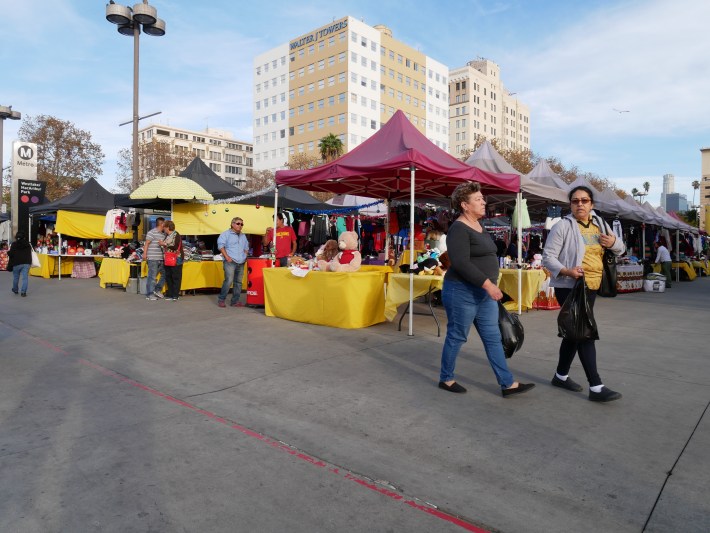 Neatly aligned rows of larger tables and canopies mark Metro's pilot vending program at MacArthur Park. The district set-up contrasts with the preference many of the sidewalk vendors have for smaller tables and umbrellas that allow them to be closer to other vendors. Photo: Monique López