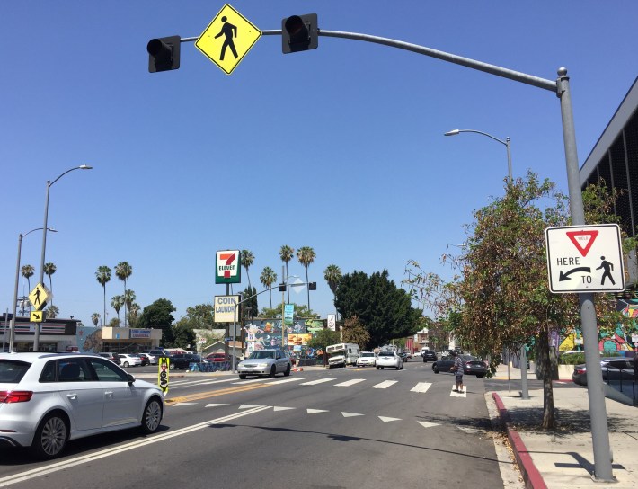 Earlier, L.A.'s Vision Zero program enhanced this pedestrian crossing at Beverly and Vendome, though the in-street signs have been damaged by graffiti and by cars crashing into them (note the sign on the far side of the intersection is missing)